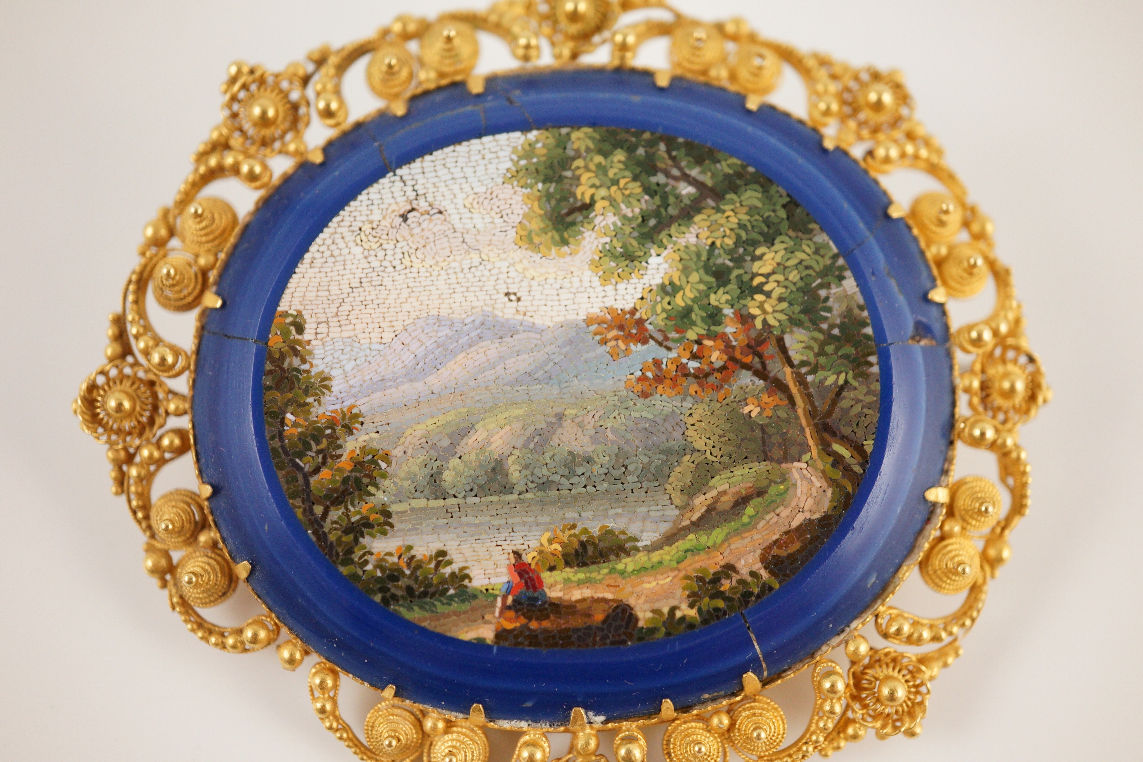 A 19th century Italian gold mounted micro-mosaic oval brooch